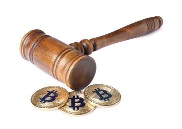 Photo of Cryptocurrency. Bitcoins and judge's gavel isolated on white