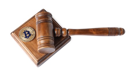 Photo of Cryptocurrency. Bitcoin and judge's gavel isolated on white, above view