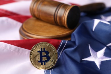 Photo of Cryptocurrency. Bitcoin and judge's gavel on American flag, closeup