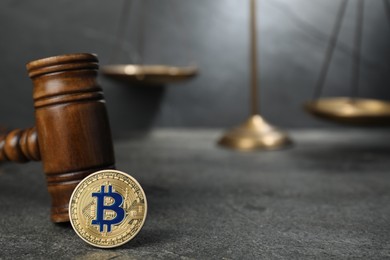 Photo of Cryptocurrency. Bitcoin, judge's gavel and scales on grey table, closeup. Space for text