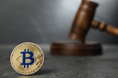Photo of Cryptocurrency. Bitcoin and judge's gavel on grey table, closeup. Space for text