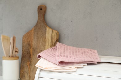 Photo of Clean waffle towels on breadbox in kitchen, closeup