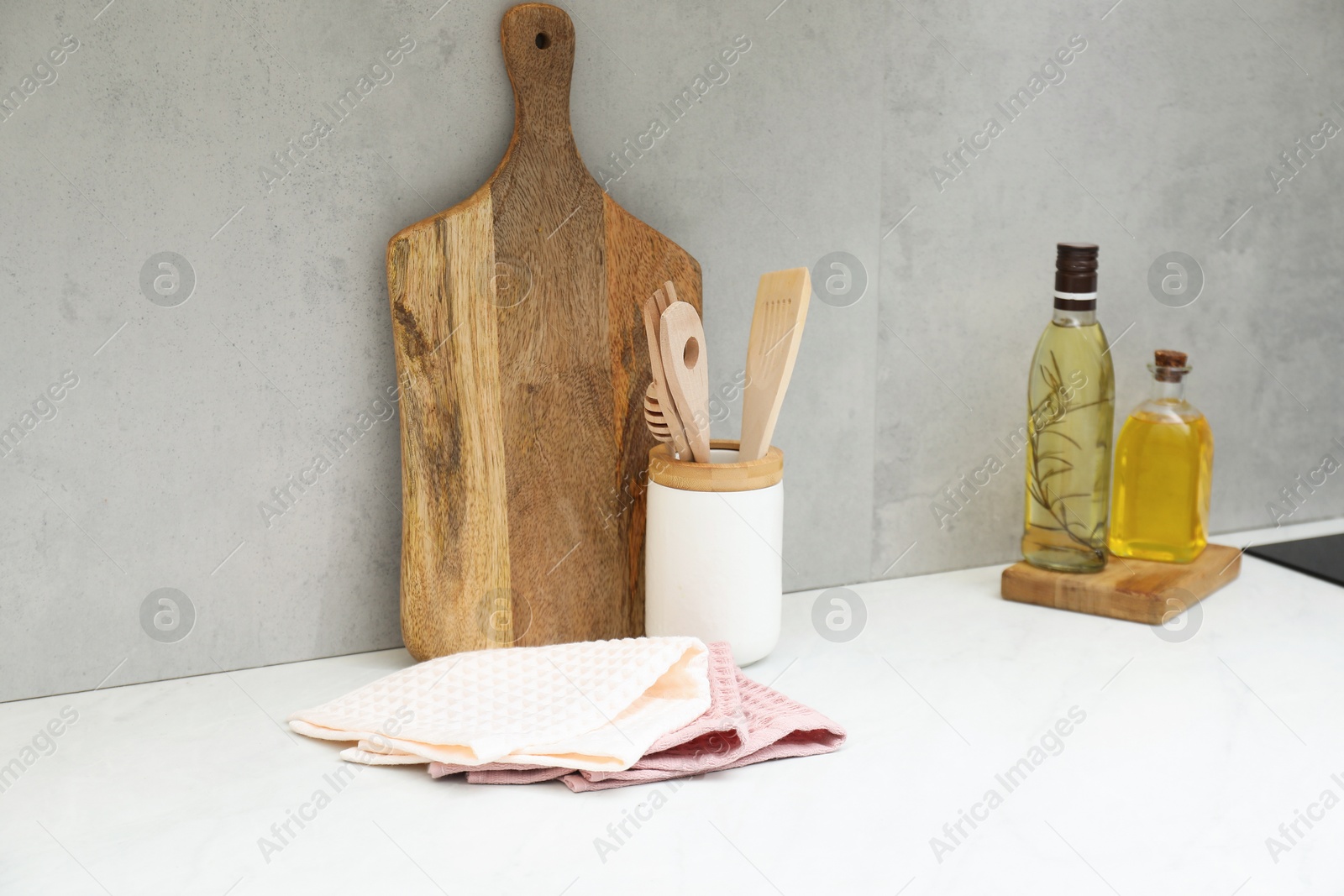 Clean waffle towels, utensils and cutting board on countertop in kitchen Photo of Clean waffle towels, utensils and cutting board on countertop in kitchen