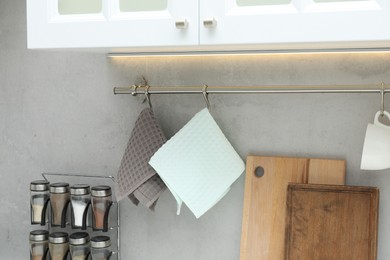 Photo of Clean waffle towels, cutting boards and spices in kitchen, closeup