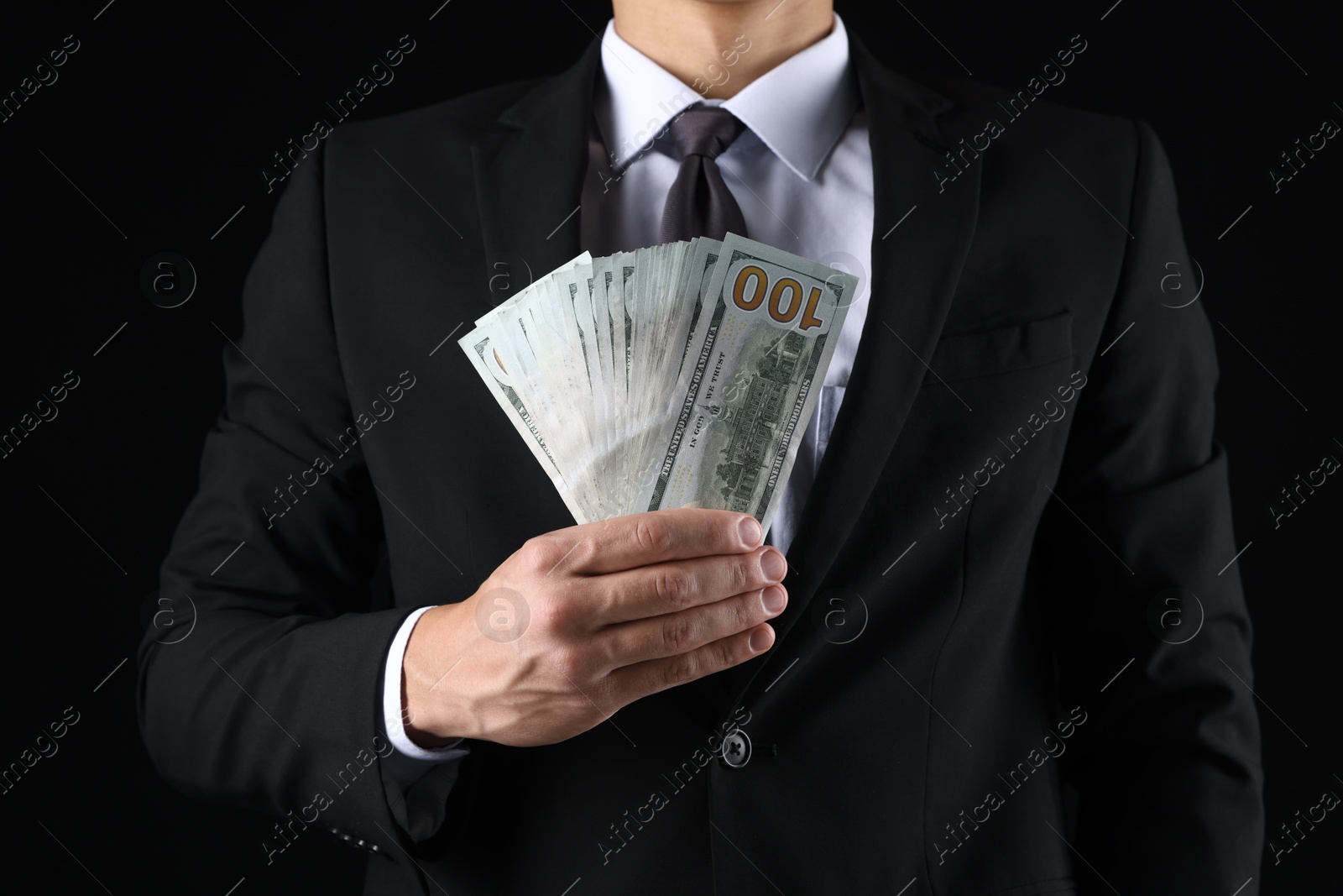 Man with dollar bills on black background, closeup Photo of Man with dollar bills on black background, closeup