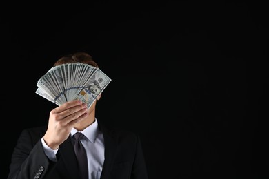 Photo of Man with dollar bills on black background, space for text