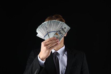 Photo of Man with dollar bills on black background
