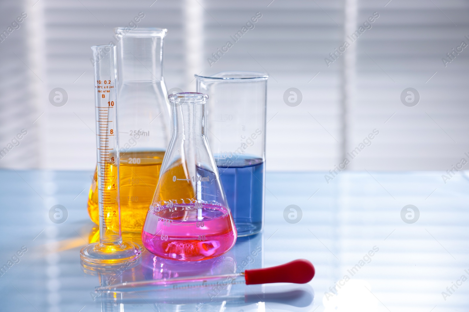 Photo of Laboratory glassware with different samples on light table
