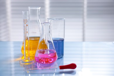 Photo of Laboratory glassware with different samples on light table