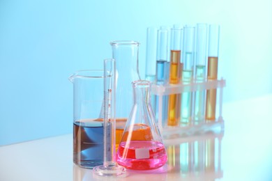 Photo of Laboratory glassware with different samples on light table
