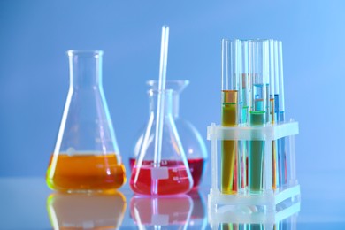 Photo of Laboratory glassware with different samples on light table