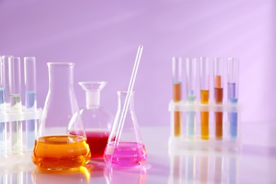 Photo of Laboratory glassware with different samples on light table