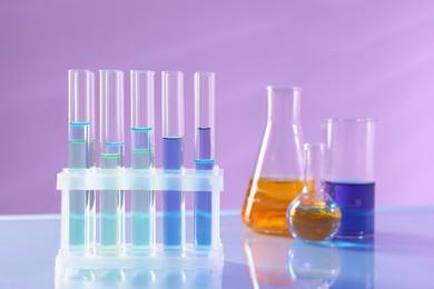 Photo of Laboratory glassware with different samples on light table