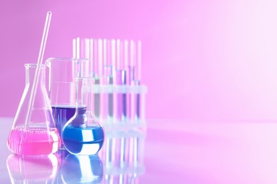 Photo of Laboratory glassware with different samples on light table. Space for text