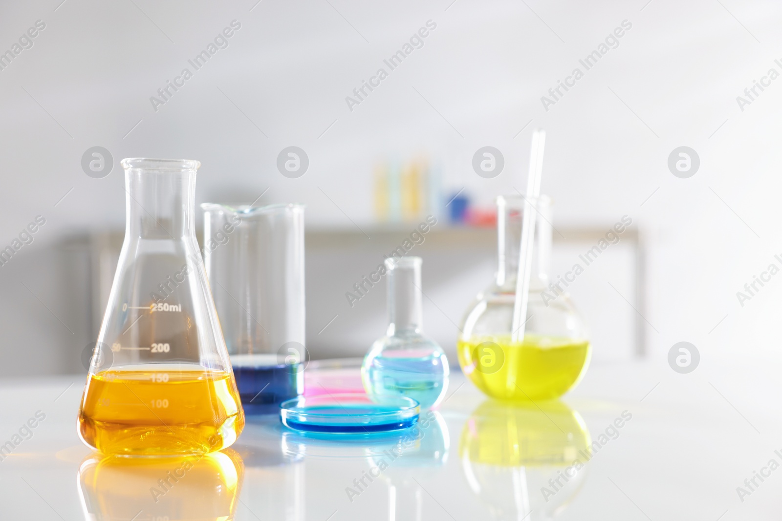 Photo of Laboratory glassware with different samples on light table