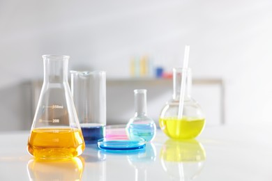 Photo of Laboratory glassware with different samples on light table