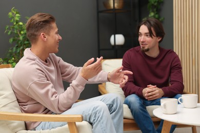 Photo of Friends talking while having tea at home