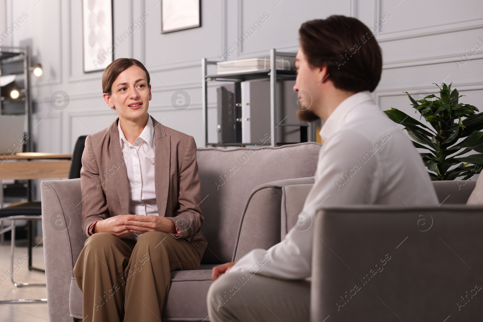Colleagues having discussion in armchairs at office Photo of Colleagues having discussion in armchairs at office