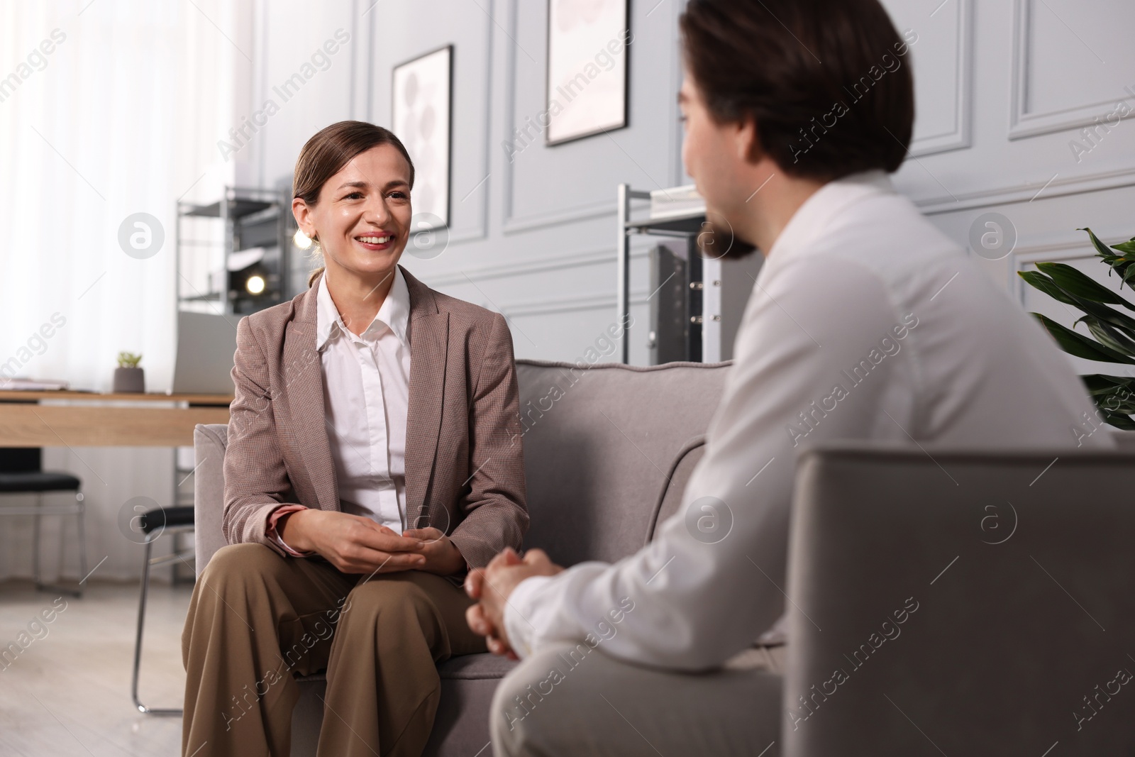 Photo of Woman having discussion with her colleague in armchairs at office