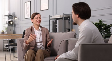 Photo of Colleagues having discussion in armchairs at office