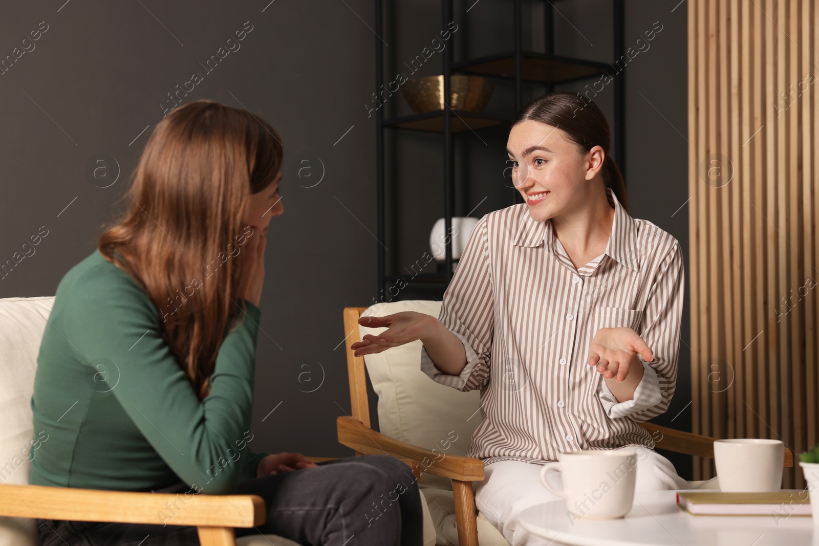 Photo of Friends talking while having tea at home