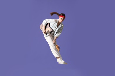 Photo of Woman with guitar jumping on purple background