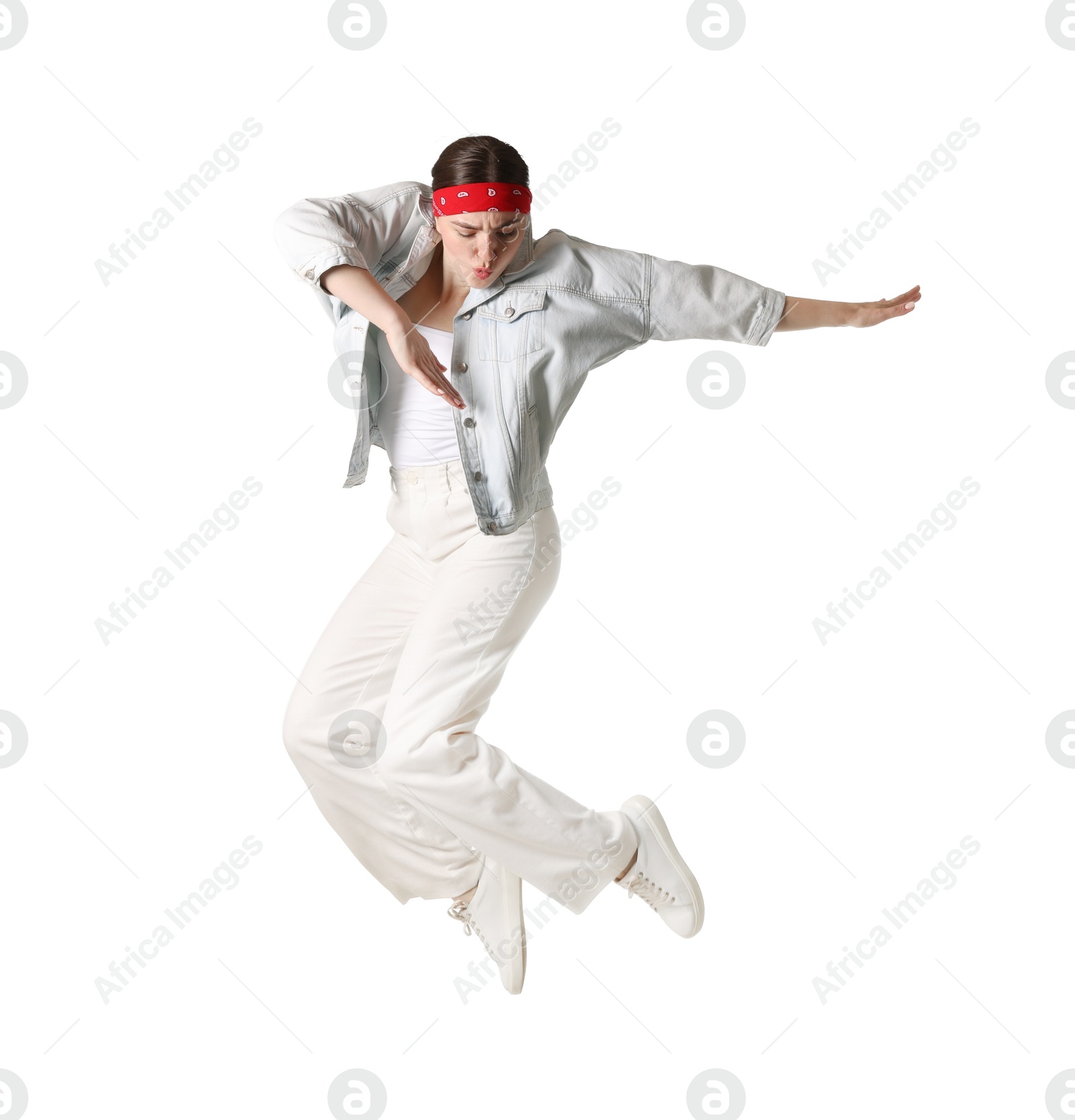 Woman in stylish outfit jumping on white background Photo of Woman in stylish outfit jumping on white background