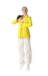 Photo of Woman in yellow jacket jumping on white background