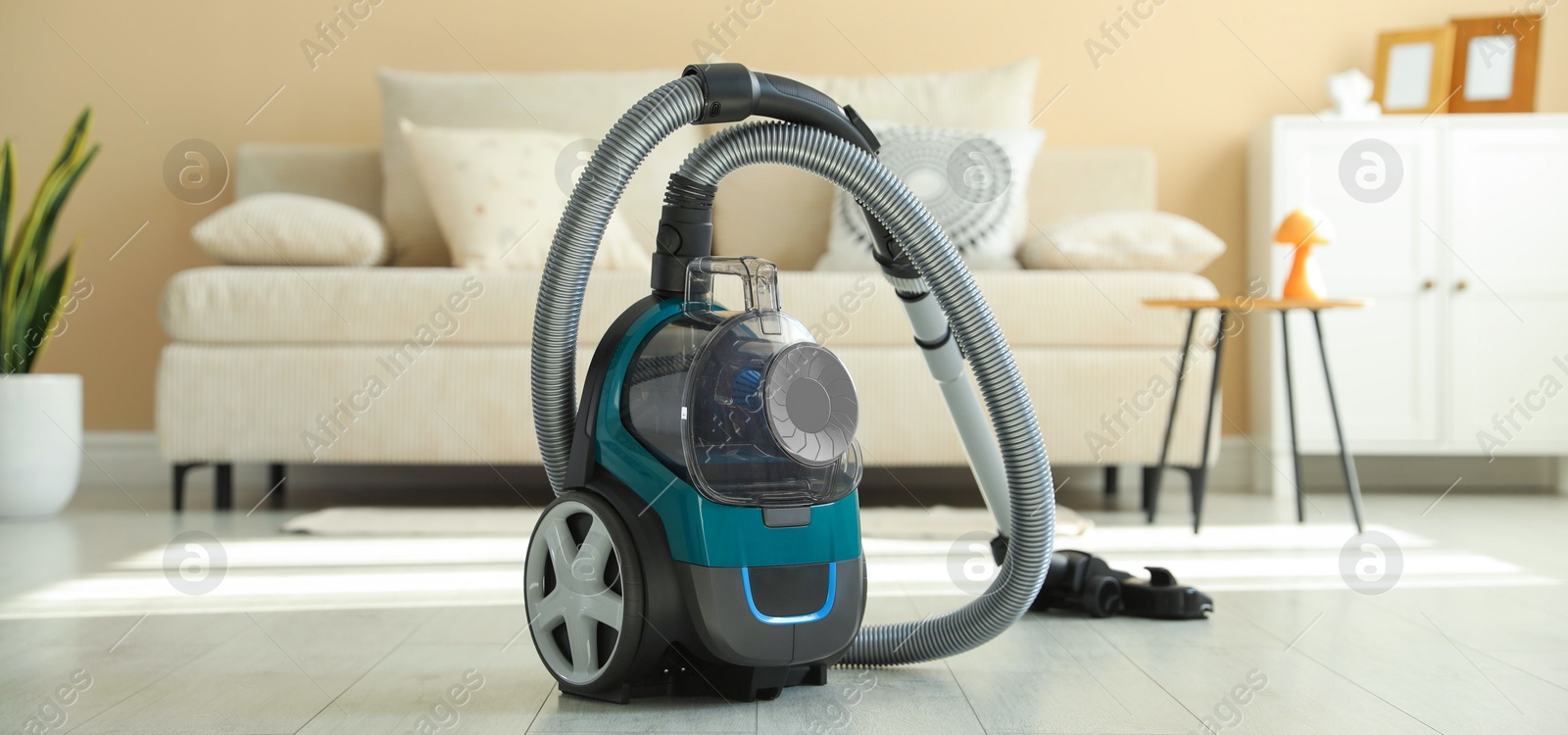 One vacuum cleaner on floor indoors. Household appliance Photo of One vacuum cleaner on floor indoors. Household appliance