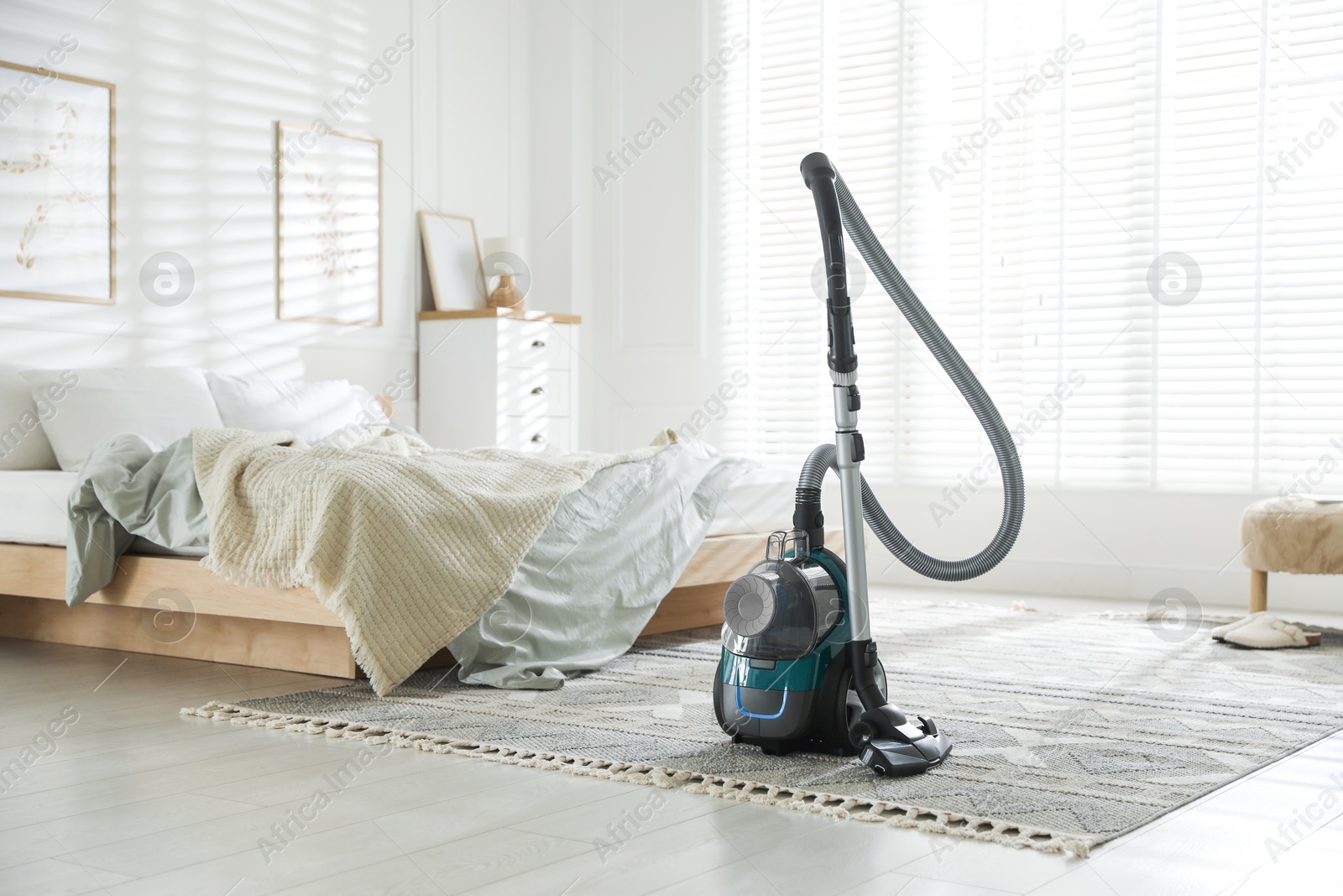 One vacuum cleaner on floor in bedroom. Household appliance Photo of One vacuum cleaner on floor in bedroom. Household appliance