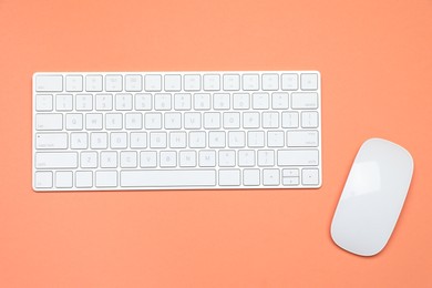 Photo of Modern white wireless keyboard and mouse on color background, top view
