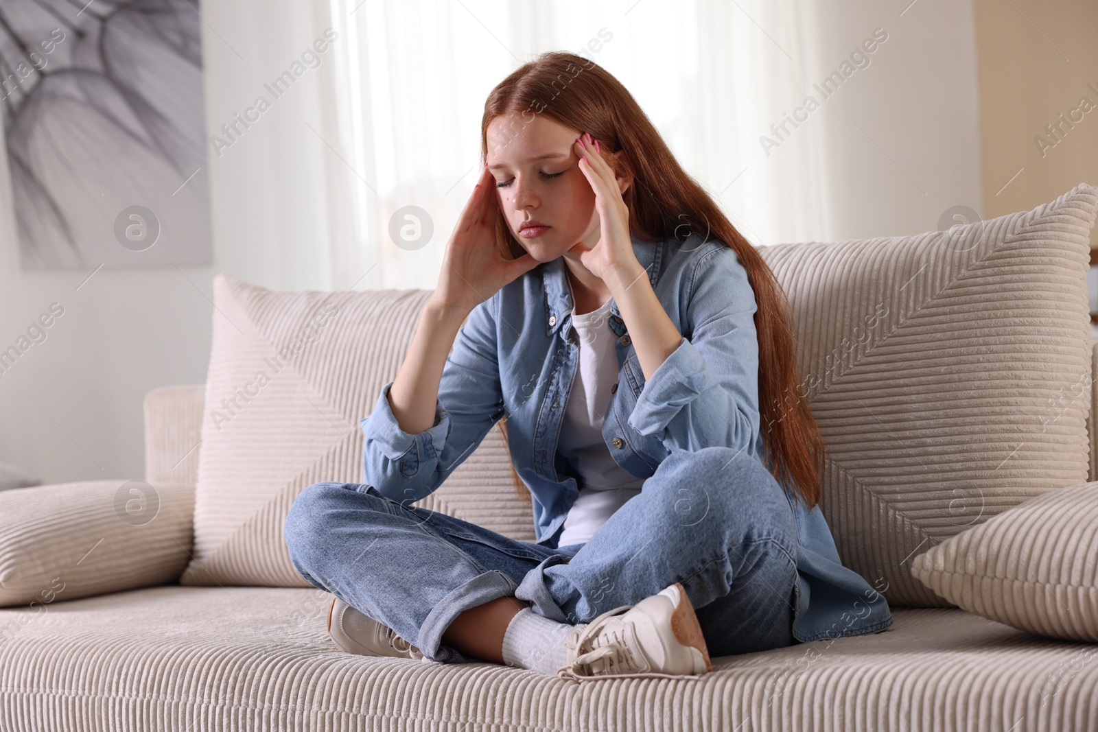 Teenage girl deep breathing on sofa at home. Way to stop panic attack Photo of Teenage girl deep breathing on sofa at home. Way to stop panic attack