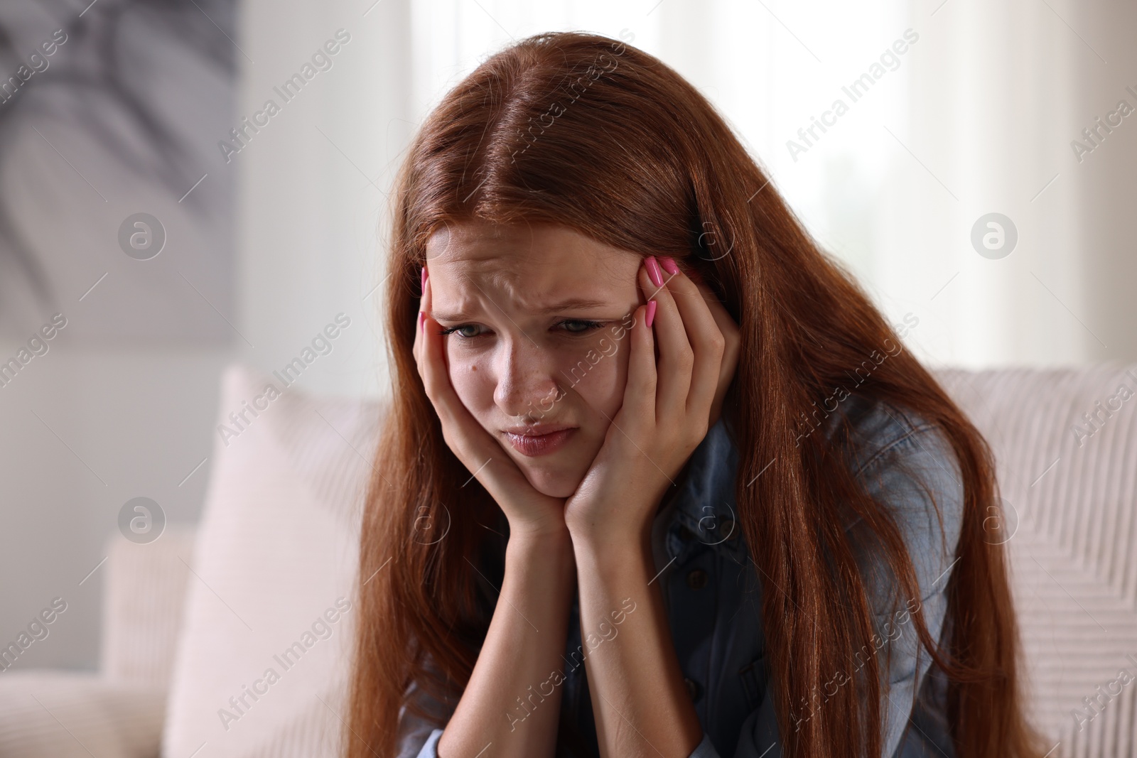 Teenage girl suffering from panic attack at home Photo of Teenage girl suffering from panic attack at home