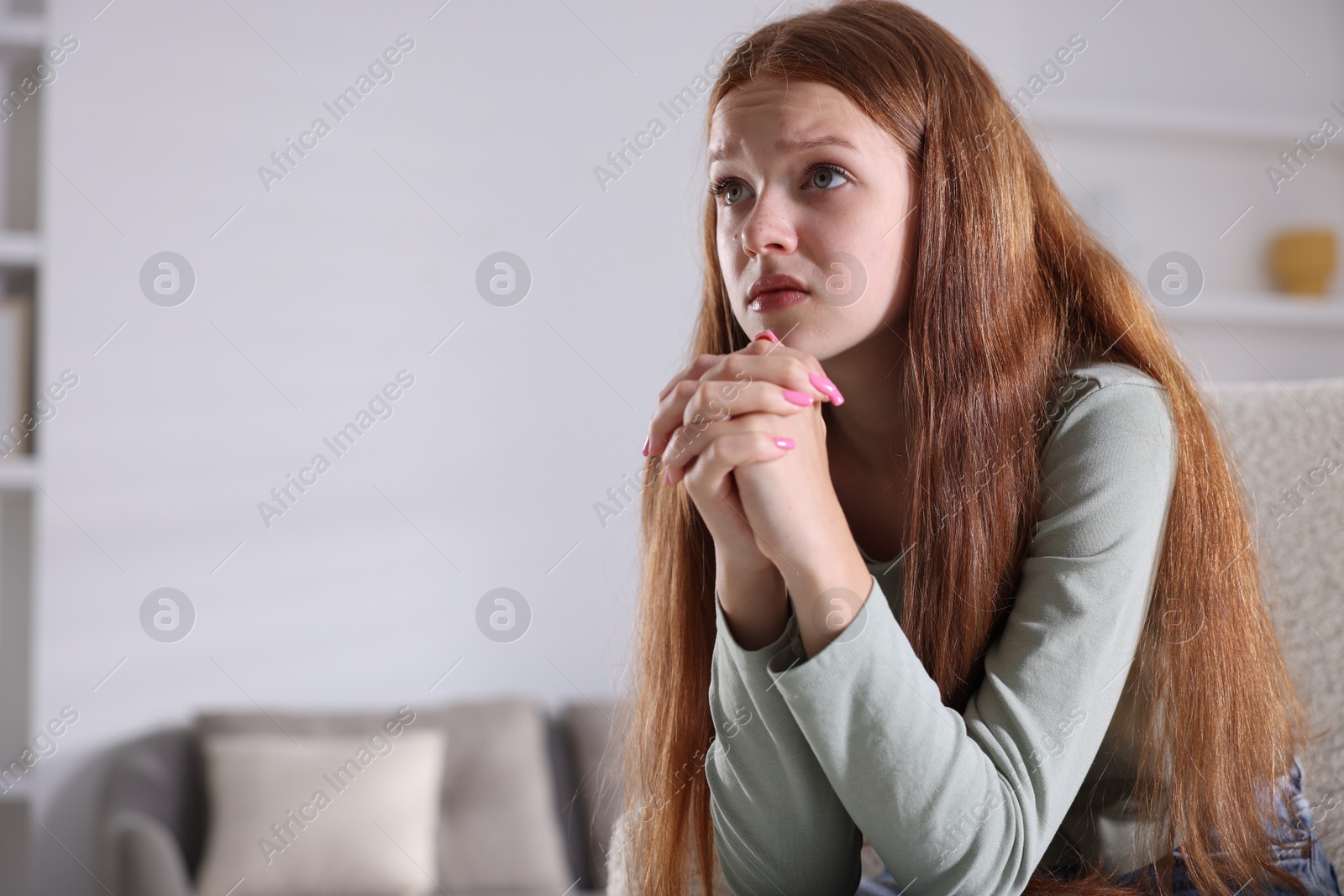 Teenage girl suffering from panic attack at home. Space for text Photo of Teenage girl suffering from panic attack at home. Space for text