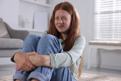 Photo of Teenage girl suffering from panic attack at home