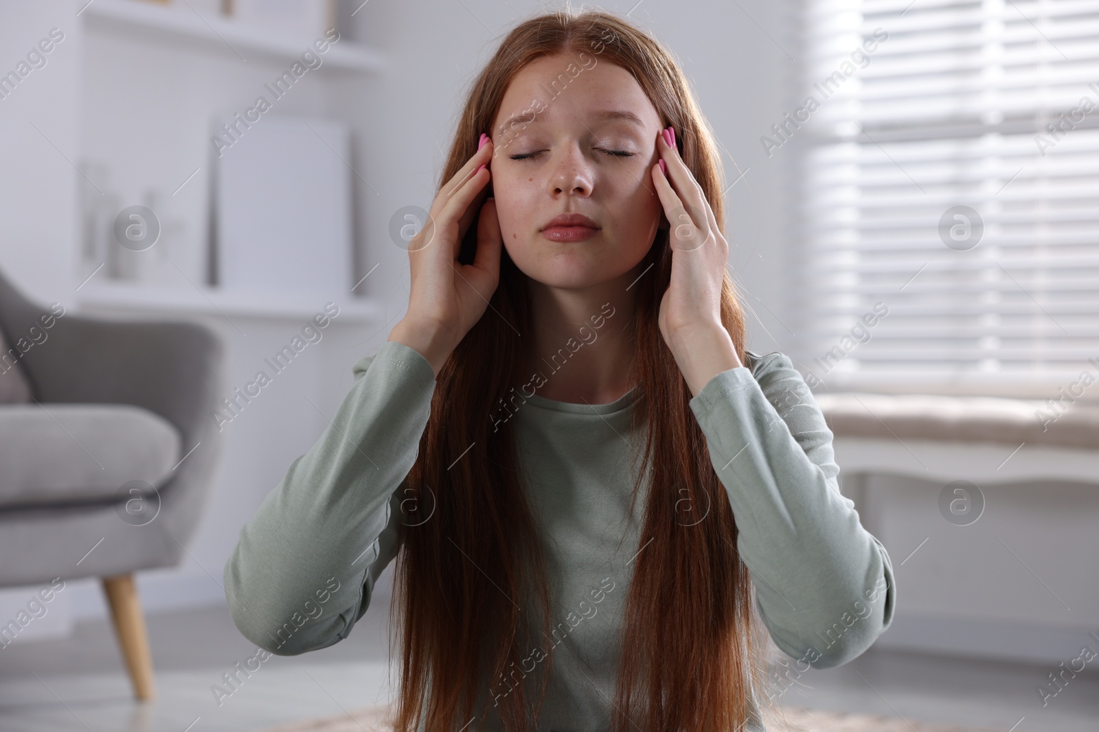 Teenage girl meditating at home. Way to stop panic attack Photo of Teenage girl meditating at home. Way to stop panic attack