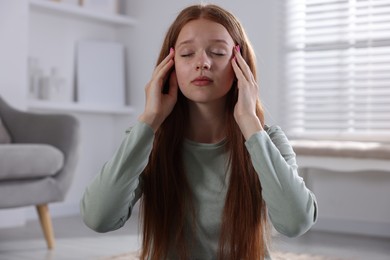 Photo of Teenage girl meditating at home. Way to stop panic attack