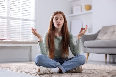 Photo of Teenage girl meditating on floor at home. Way to stop panic attack