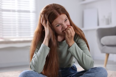 Photo of Teenage girl suffering from panic attack at home