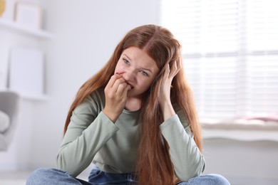 Photo of Teenage girl suffering from panic attack at home