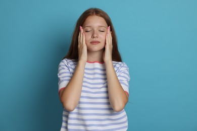 Photo of Teenage girl meditating on light blue background. Way to stop panic attack