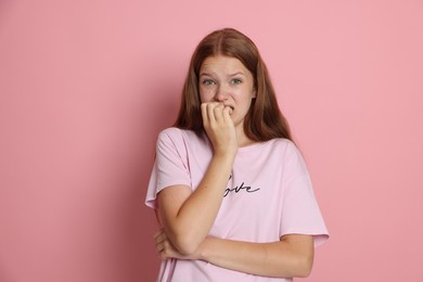 Photo of Teenage girl suffering from panic attack on pink background