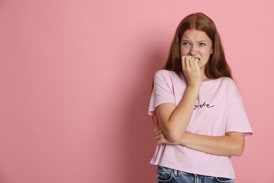 Photo of Teenage girl suffering from panic attack on pink background. Space for text