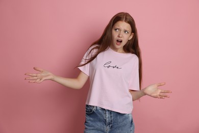 Photo of Teenage girl suffering from panic attack on pink background