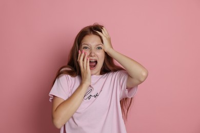 Photo of Teenage girl suffering from panic attack on pink background