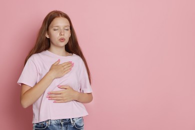 Photo of Teenage girl deep breathing on pink background, space for text. Way to stop panic attack