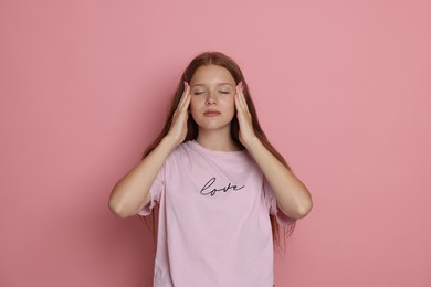 Photo of Teenage girl meditating on pink background. Way to stop panic attack