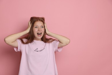 Photo of Teenage girl suffering from panic attack on pink background. Space for text