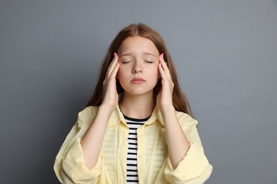 Photo of Teenage girl meditating on grey background. Way to stop panic attack