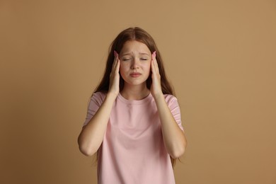 Photo of Teenage girl meditating on beige background. Way to stop panic attack